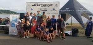 A group of people posing for a picture in front of a tent at Supreme Boats.
