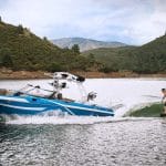 Supreme S238 action wake surfing with mountains in background