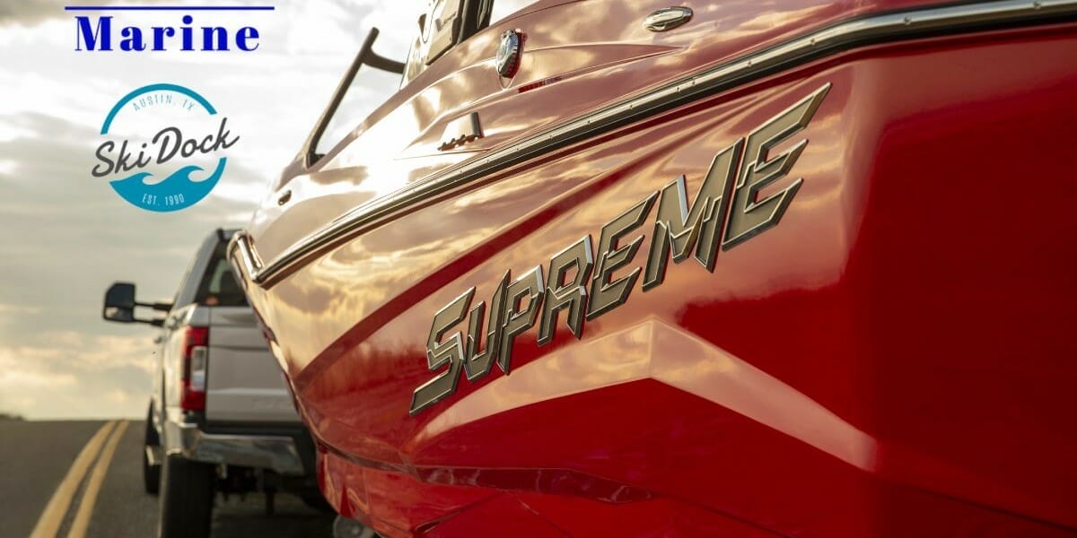 A Supreme boat is parked on the side of the road.