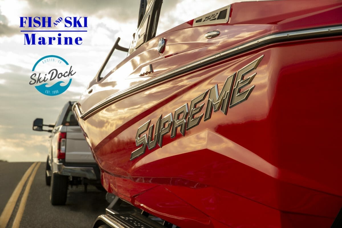 A Supreme boat is parked on the side of the road.
