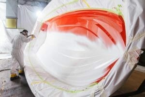 Worker spraying gel coat at Supreme factory