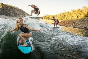 Three surfers on one wake