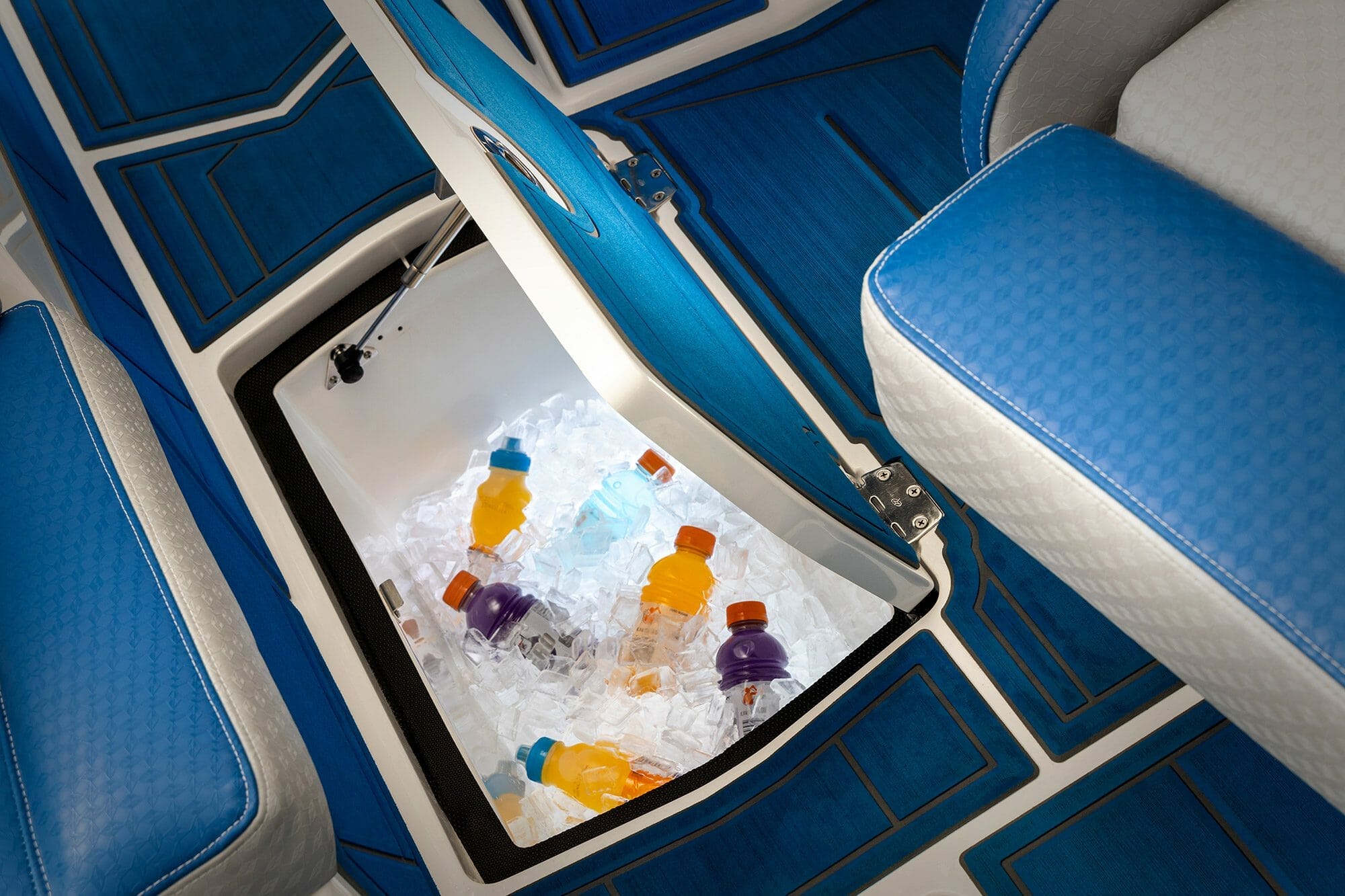The interior of a Supreme Boat with a cooler in it.