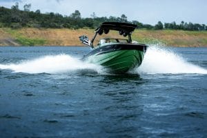 Green Supreme S240 boat cutting through rough water