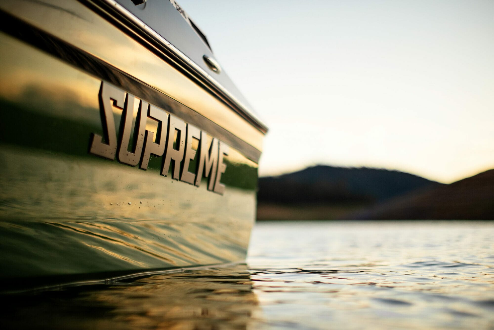 Supreme logo on the side of a S240 boat in the water