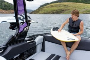 Waxing surf board within a Supreme boat