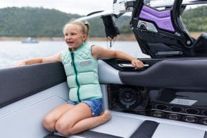 Cute young girl smiling inside a Purple S220 Supreme boat