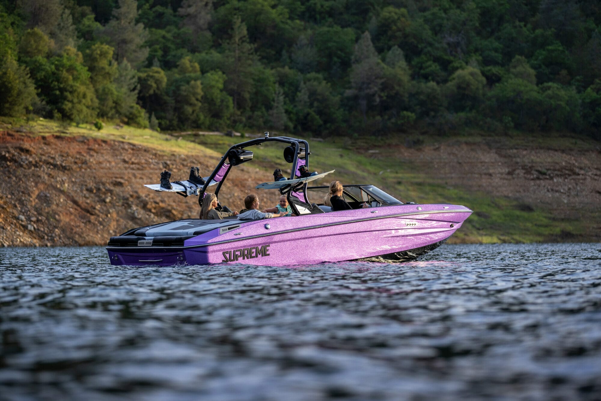 Purple S220 Supreme boat still in water with boaters inside