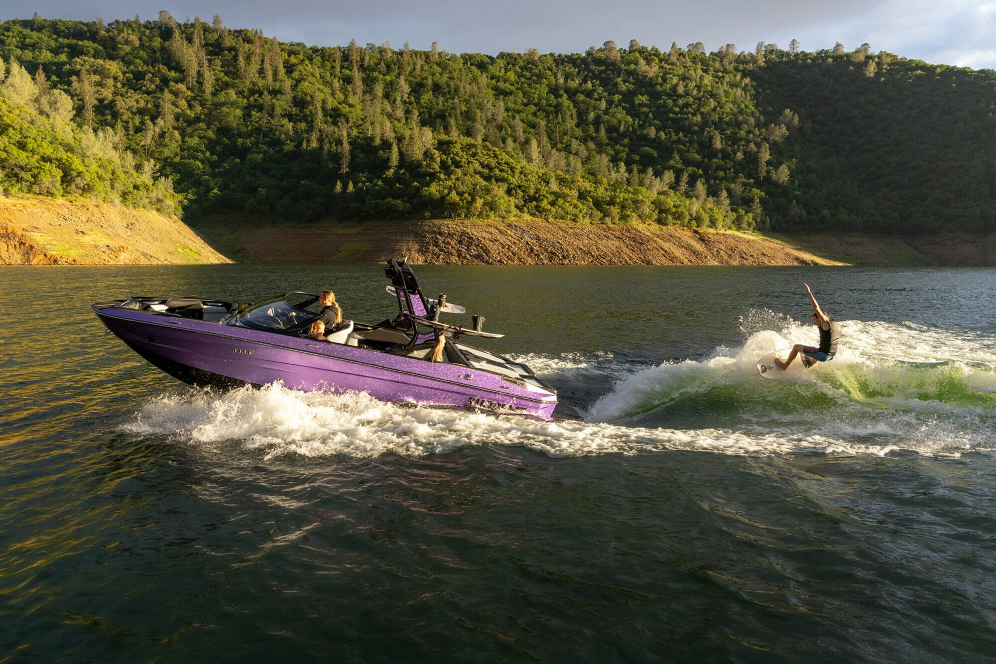wake surfer behind a purple S220 Supreme boat