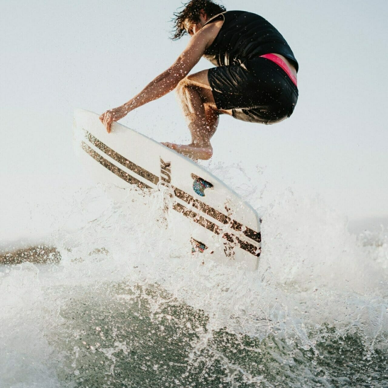 A man riding a wave on a surfboard.