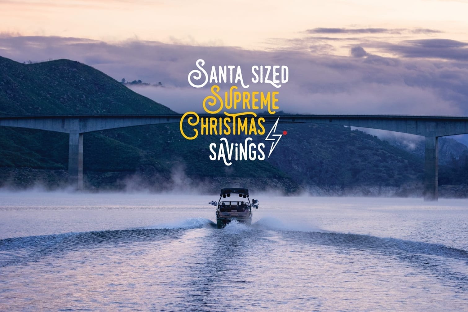 A boat on the water with a bridge in the background, showcasing Santa-Sized savings during this Supreme Christmas season.