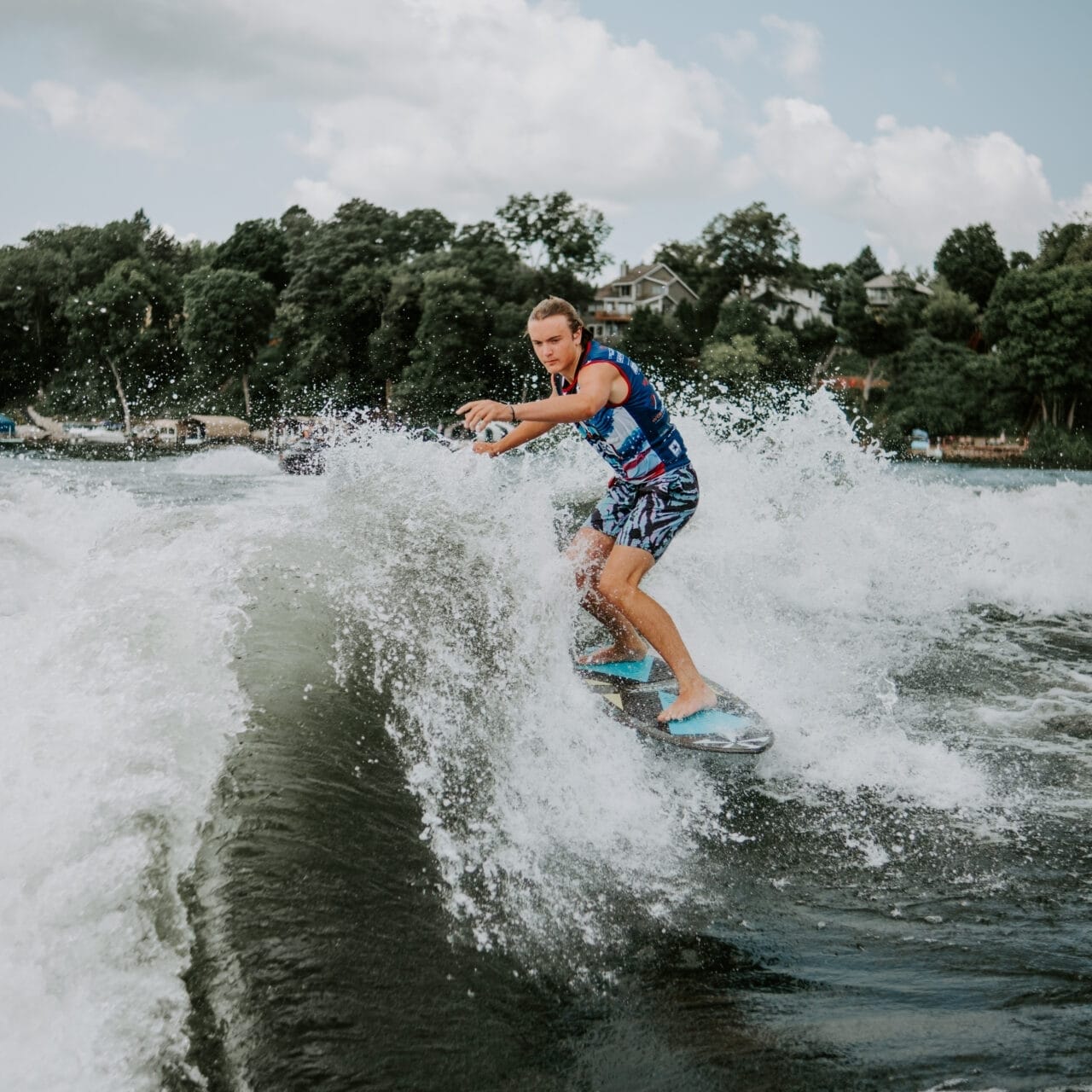 Cade Lybeck riding a wave on a surfboard.